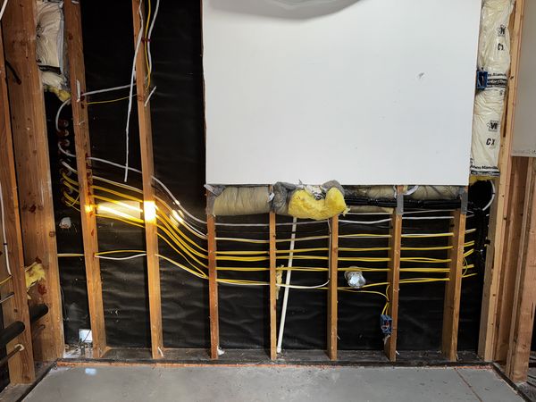 Wide view of new home-run circuits pulled across open garage framing