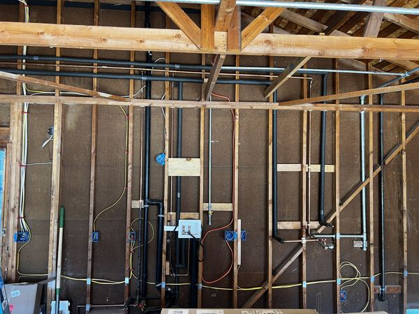 Open-stud whole-home rough-in coordinated with plumbing