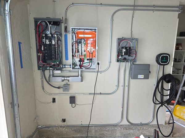 Tesla Powerwall and expansion unit mounted on the exterior wall