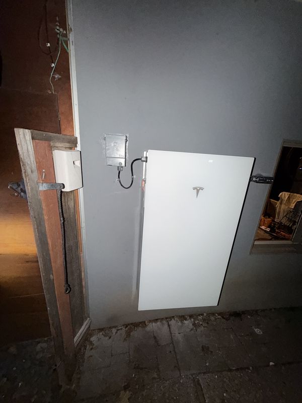 Tesla Powerwall with shutoff switch installed in a storage area