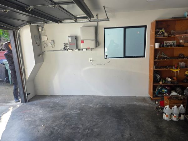 Solar inverter and monitoring equipment wall completed in the garage