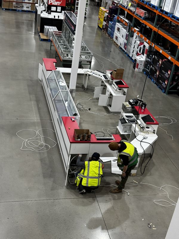 Crew wiring point-of-sale counters at the Costco Gilroy Optical department