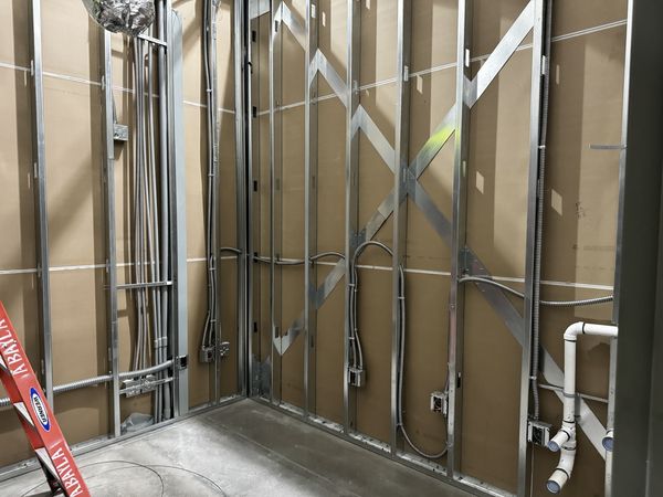 Metal-stud walls with MC cable and box rough-in for the Optical exam rooms