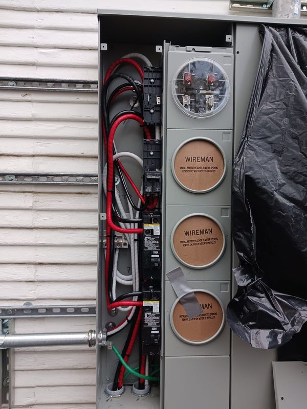 Meter stack interior with 200A breaker and service conductors before meters are set