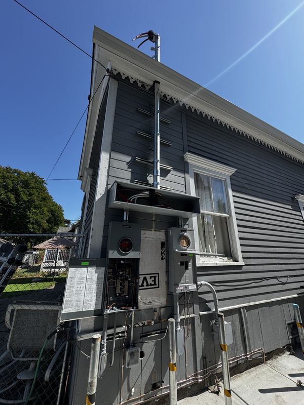 Victorian duplex service upgrade with new mast, meter-mains, and disconnects