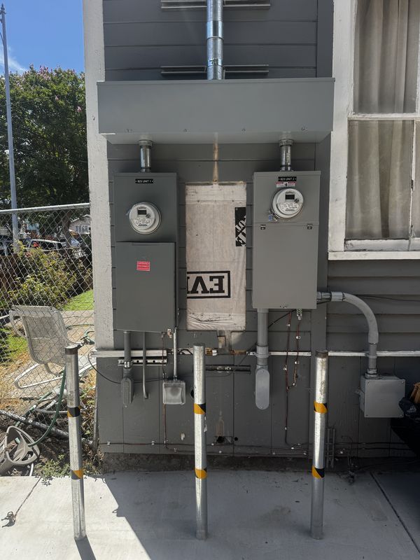 Two-unit meter-main installation protected by steel bollards