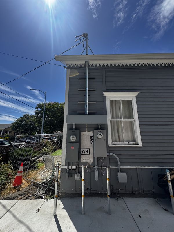 Completed two-meter service on a Victorian home with new mast and conduit