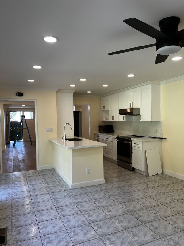 Remodeled kitchen with recessed lighting, range hood, and dedicated appliance circuits