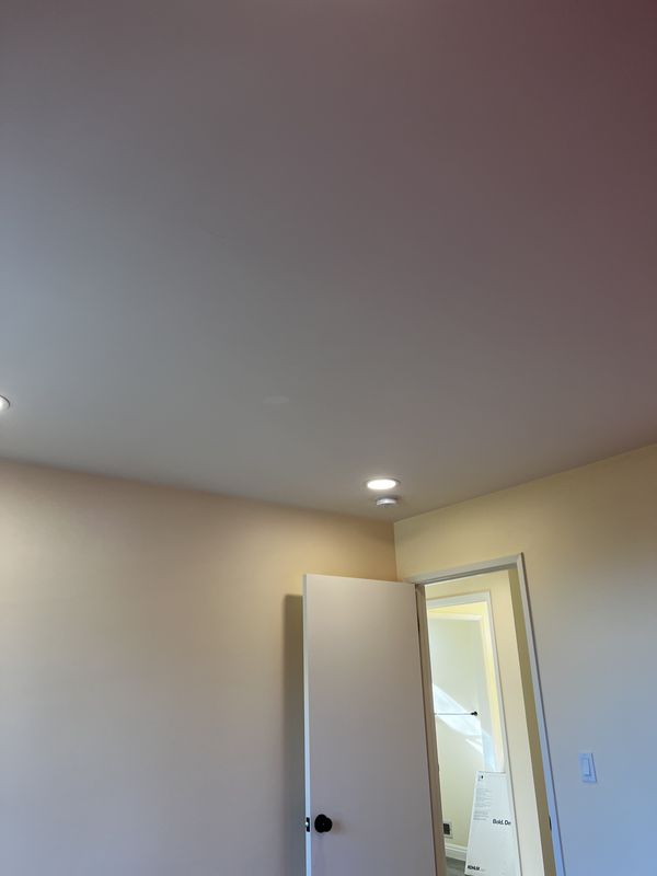Bedroom ceiling with newly installed recessed light and fresh paint