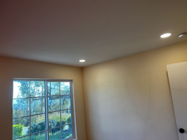 Bedroom corner with new recessed lighting installed during the whole-home rewire