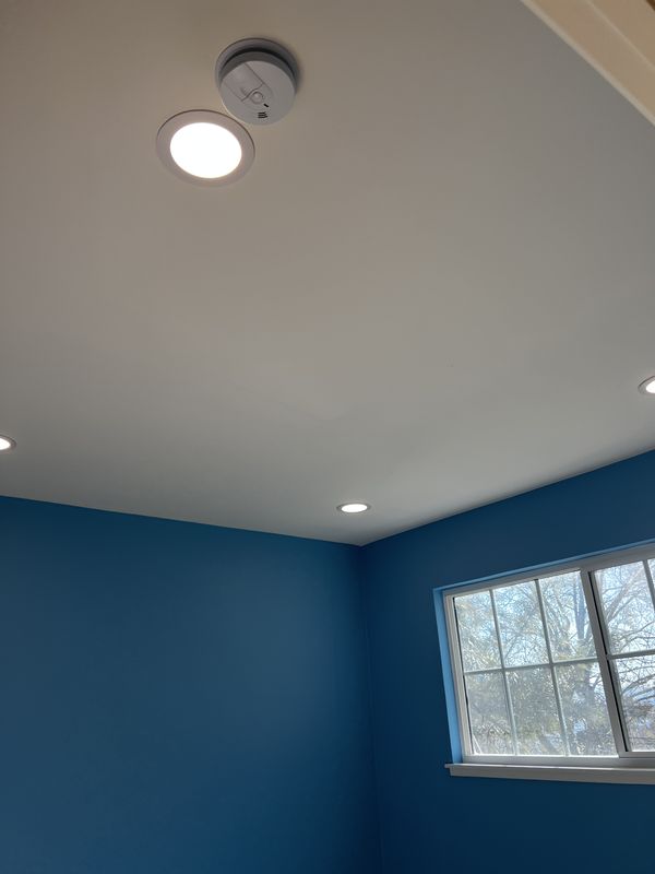 Blue bedroom with new recessed light and hardwired smoke detector per code