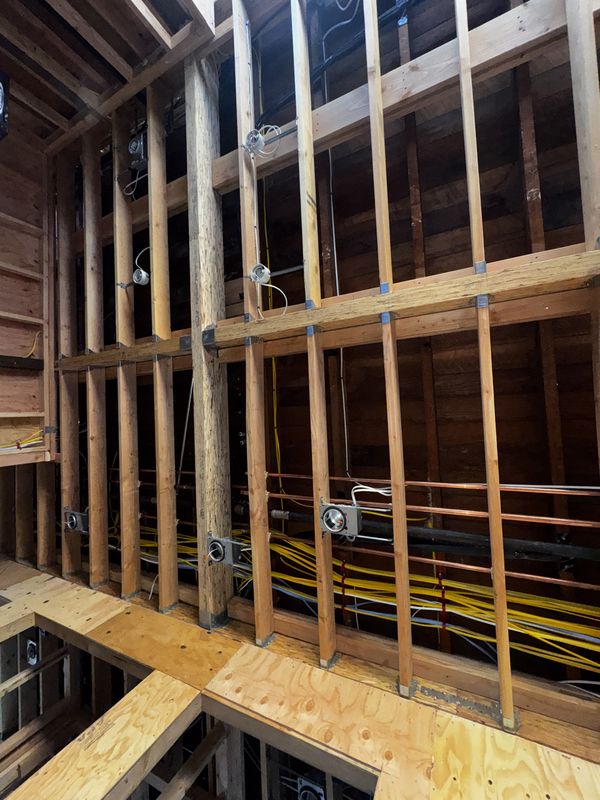 Open wall and ceiling framing with new circuits and rough-in boxes set