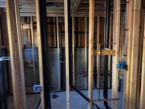 Utility-area framing with plumbing and electrical rough-in coordinated