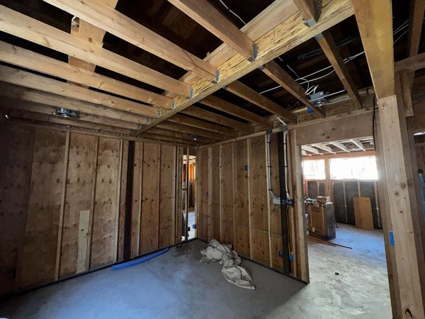 Open family-room framing with circuits routed and boxes set before drywall